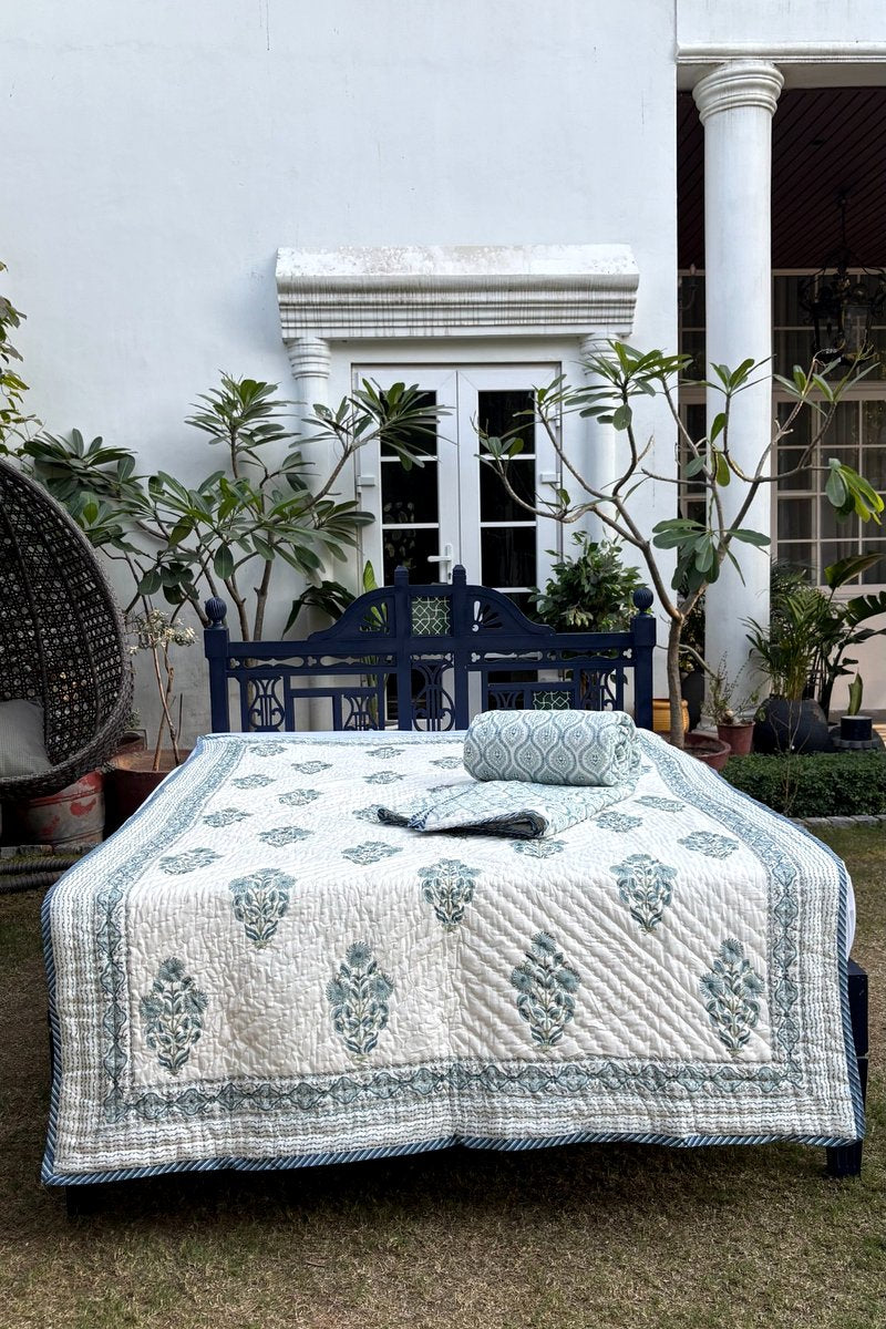 Premium cotton quilt with blue floral block print and detailed border pattern