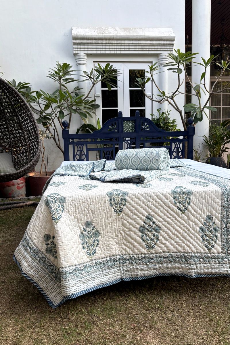 Hand block printed aqua floral quilt on ivory cotton with traditional Mughal buta design