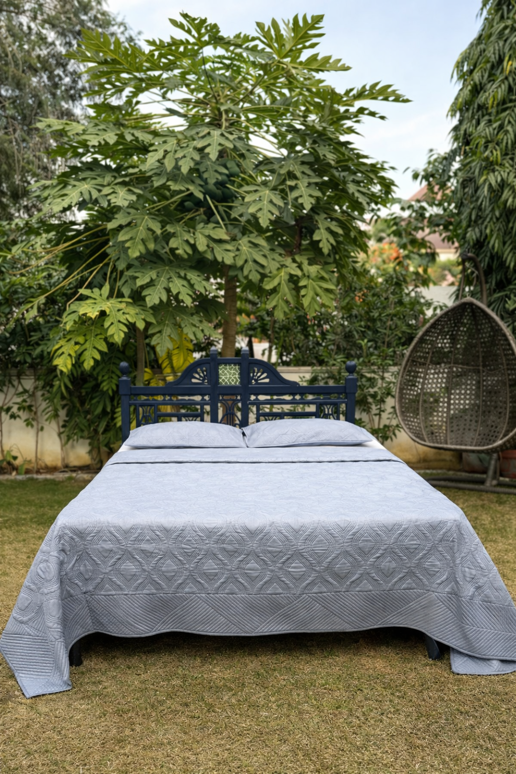 Premium ash grey quilted bedcover with matching pillow covers in outdoor garden setup