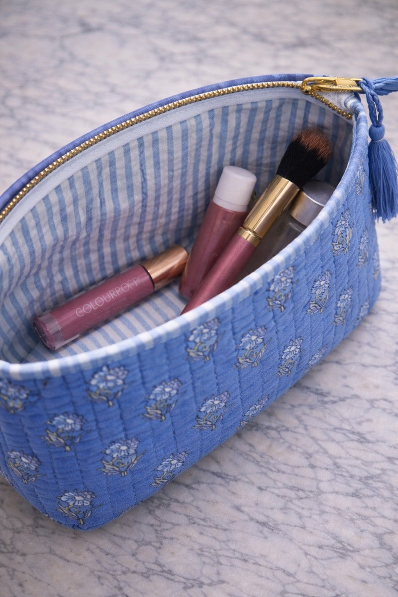 Blue floral quilted makeup bag set with tassel detail and gold zipper, organized vanity storage