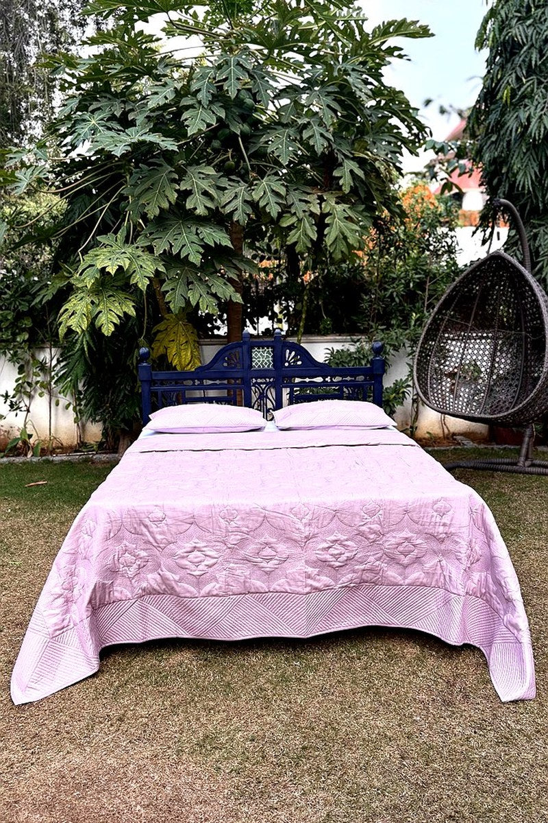 Pink hand-quilted bedcover with geometric border and matching pillow shams, premium handcrafted bedding