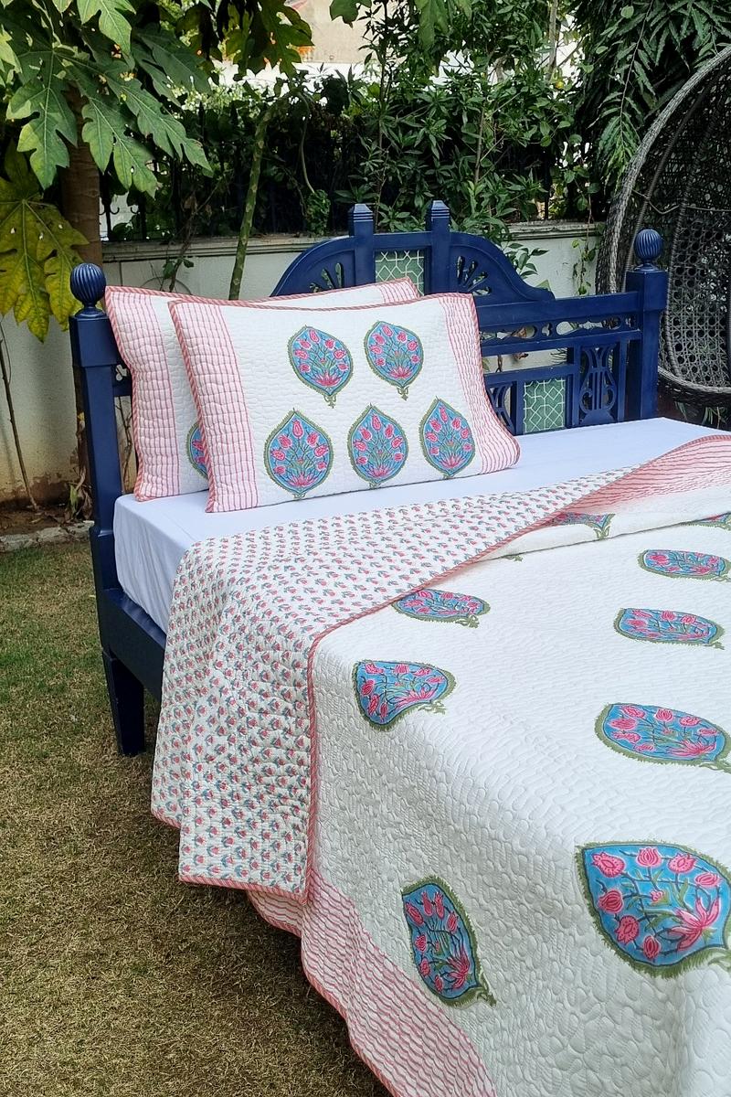 Lightweight summer quilted bedcover in cotton with turquoise bloom design