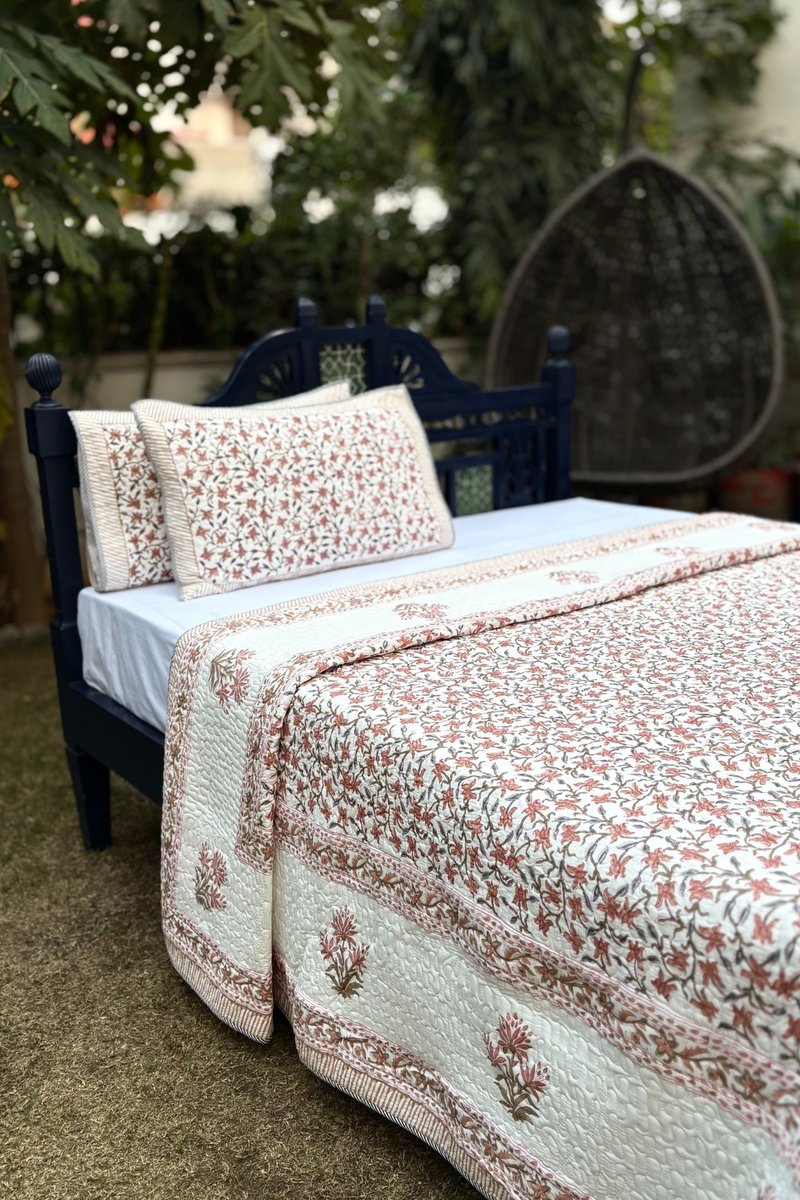 Hand block print Jaipur quilt with terracotta floral jaal and traditional border design