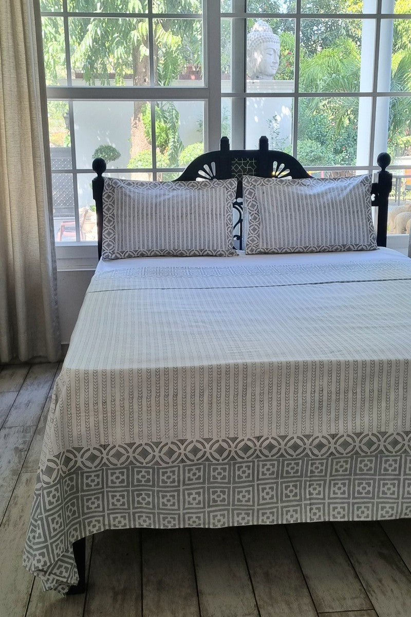 Modern neutral tone cotton bedsheet set with coordinated printed pillow covers