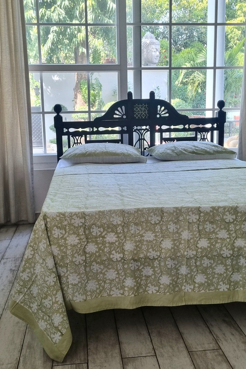 Premium sage green cotton bedsheet with white floral jaal print and coordinated pillow covers near large window