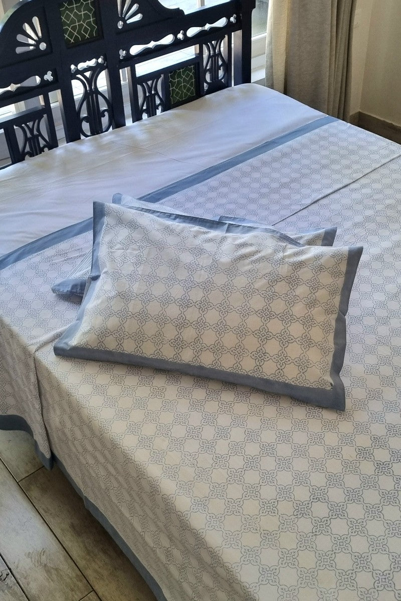Grey geometric hand block print cotton bedsheet set with blue border and matching pillow covers