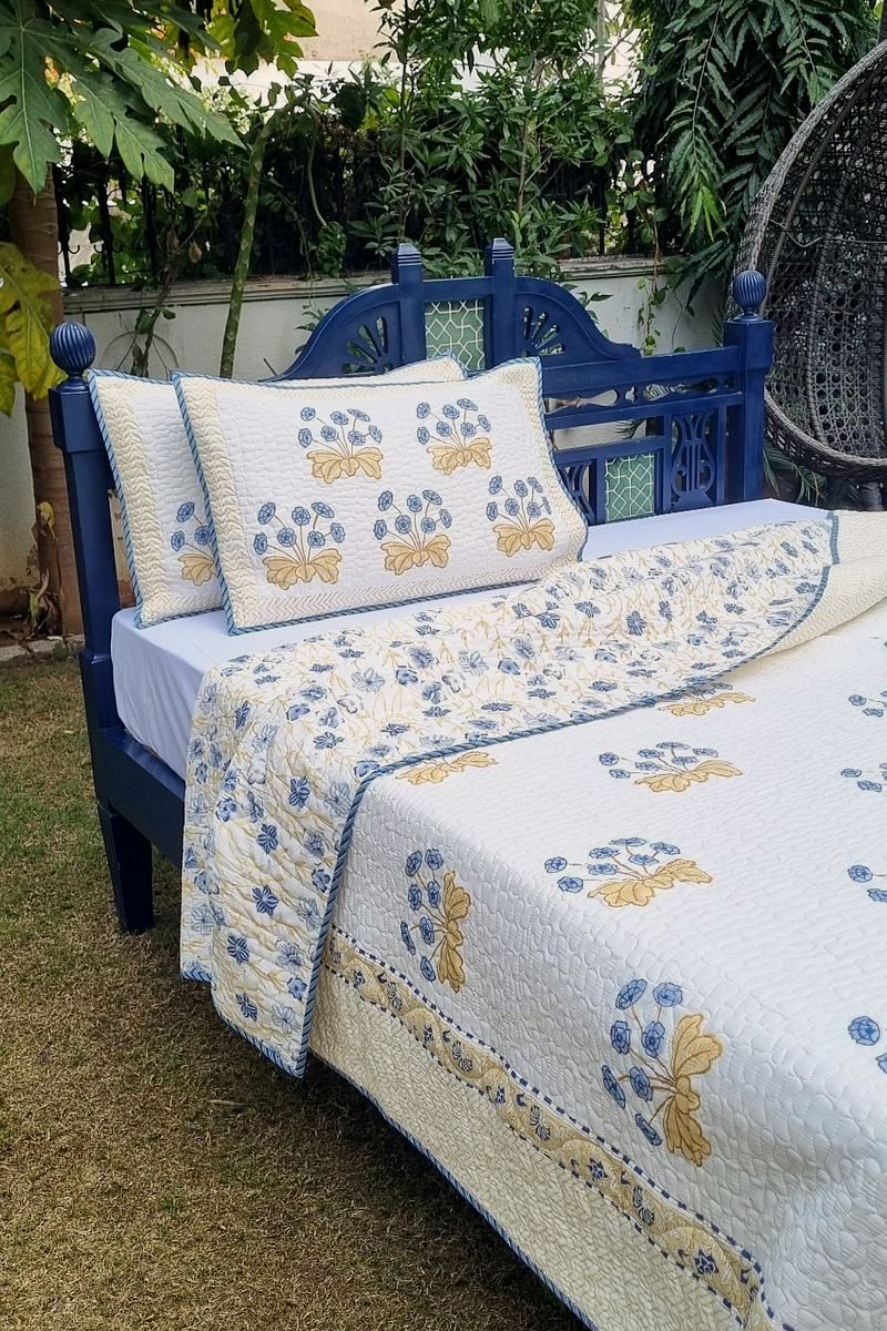 Elegant block print bedding set with floral border and quilted texture