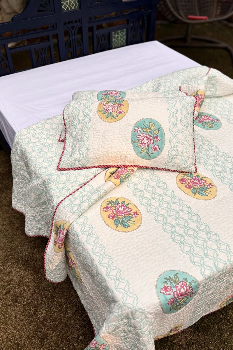 Premium reversible cotton quilted bedcover with pastel floral medallions and detailed quilting texture, summer bedspread India