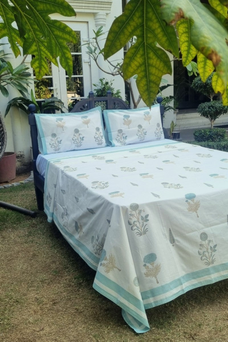 White cotton bedsheet with aqua botanical buta print and pastel border with matching pillow covers