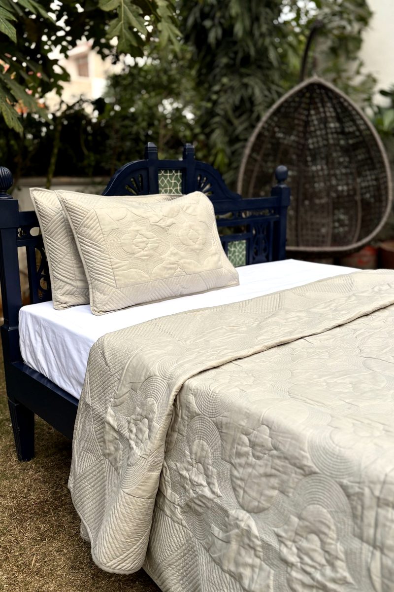 Minimal soft oatmeal bedspread with layered hand-quilted cotton texture