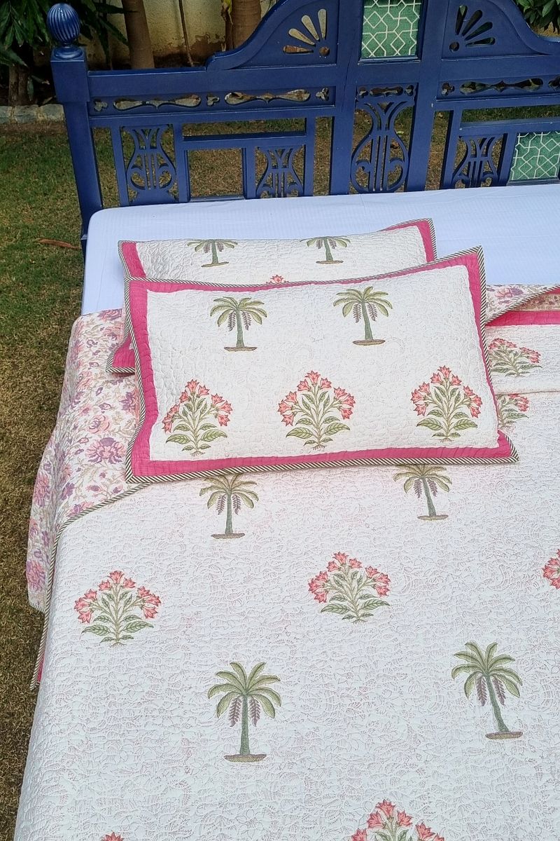 Lightweight summer bedcover in ivory with pink floral border and palm print