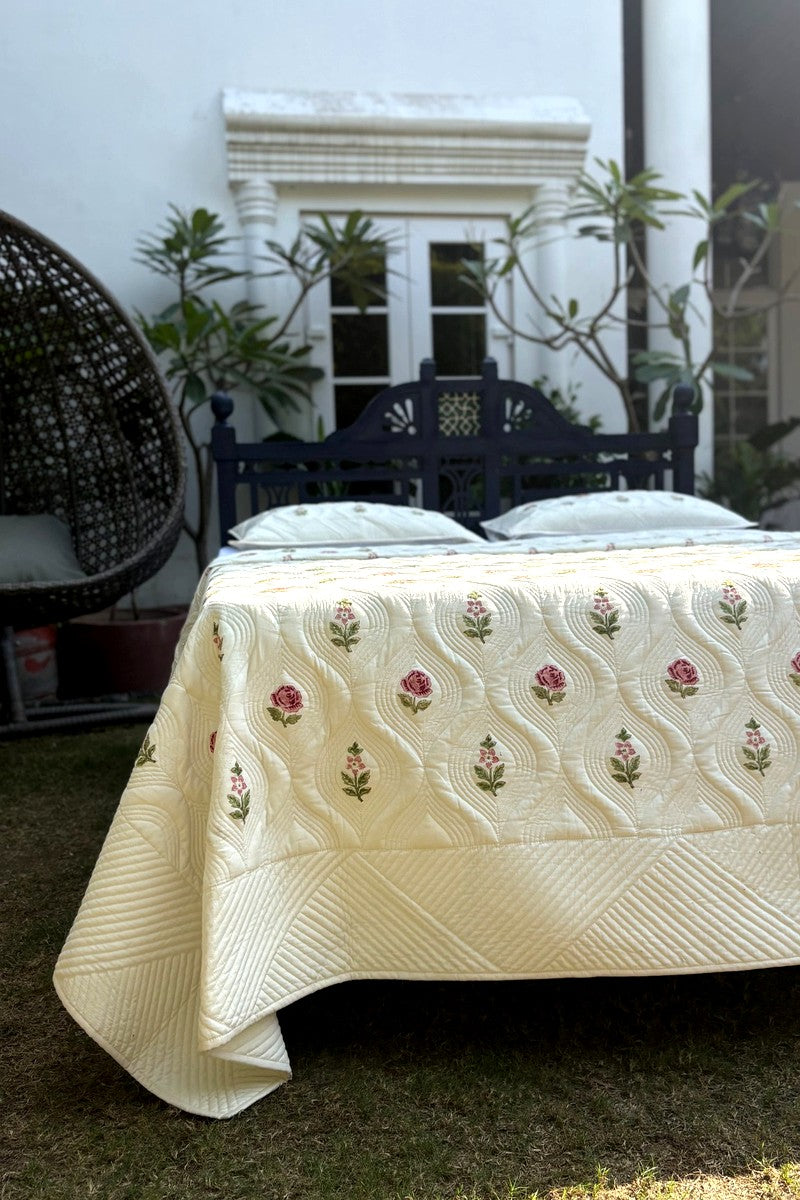 Matching quilted pillow cover with pink rose hand block floral print on cream cotton fabric, premium bedding set detail