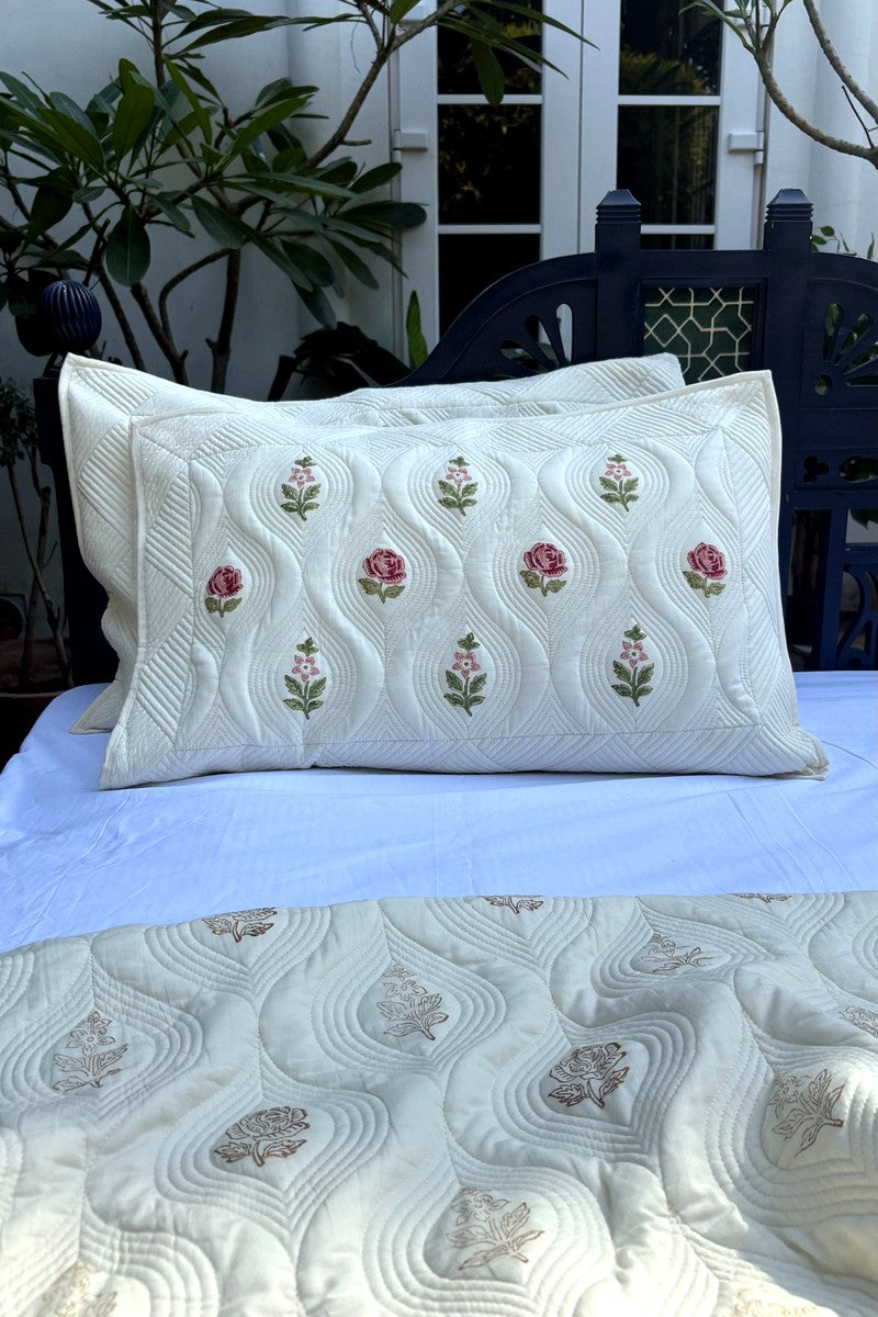 Premium cotton quilted bedcover with rose floral print and detailed wave stitching pattern, soft ivory reversible bedding set