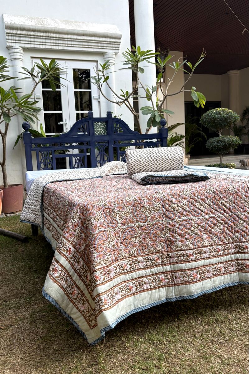 Premium hand block print quilt featuring Mughal paisley design in earthy rust, olive and muted blue