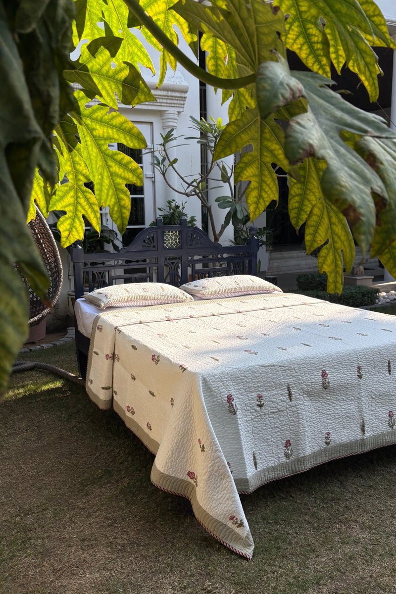 Handcrafted Indian block print quilt with small floral buti pattern in pastel pink and green