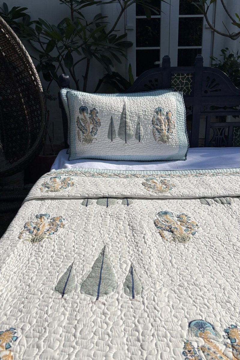 Luxury Indian cotton quilt with botanical block print and intricate vine border detailing