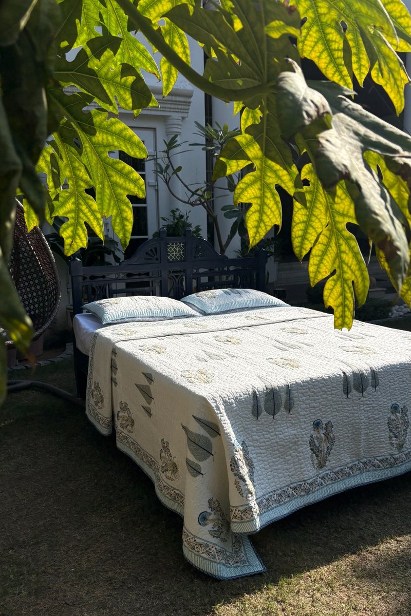 Jaipur hand block print quilt in ivory with traditional floral sprig motif and botanical border