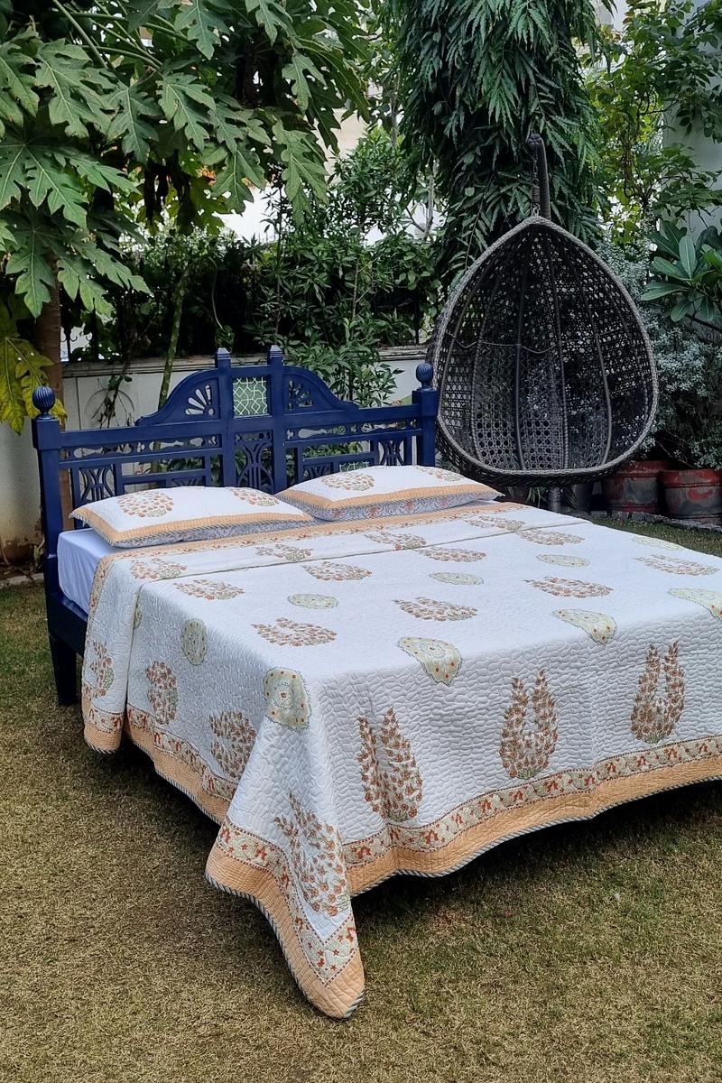 Hand block printed ivory cotton bedcover with rust peach floral buta and sage medallion motifs