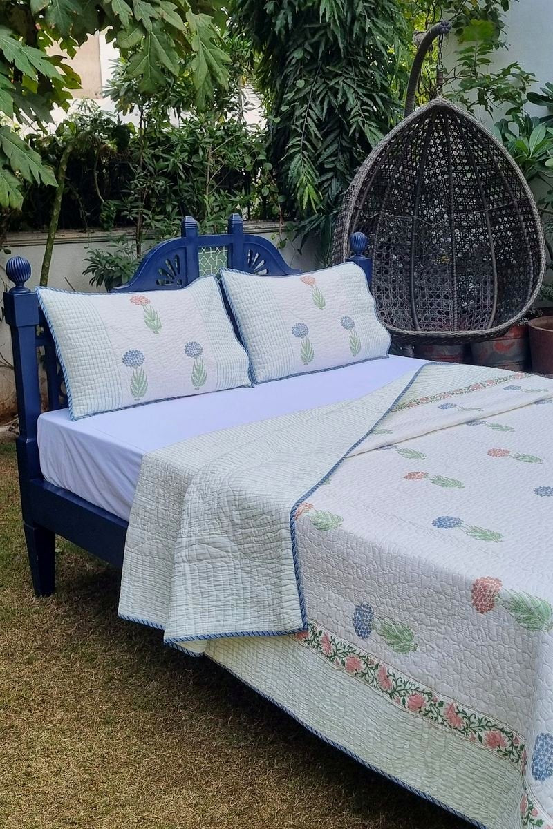 Luxury reversible cotton bedcover with blue and blush floral buta design