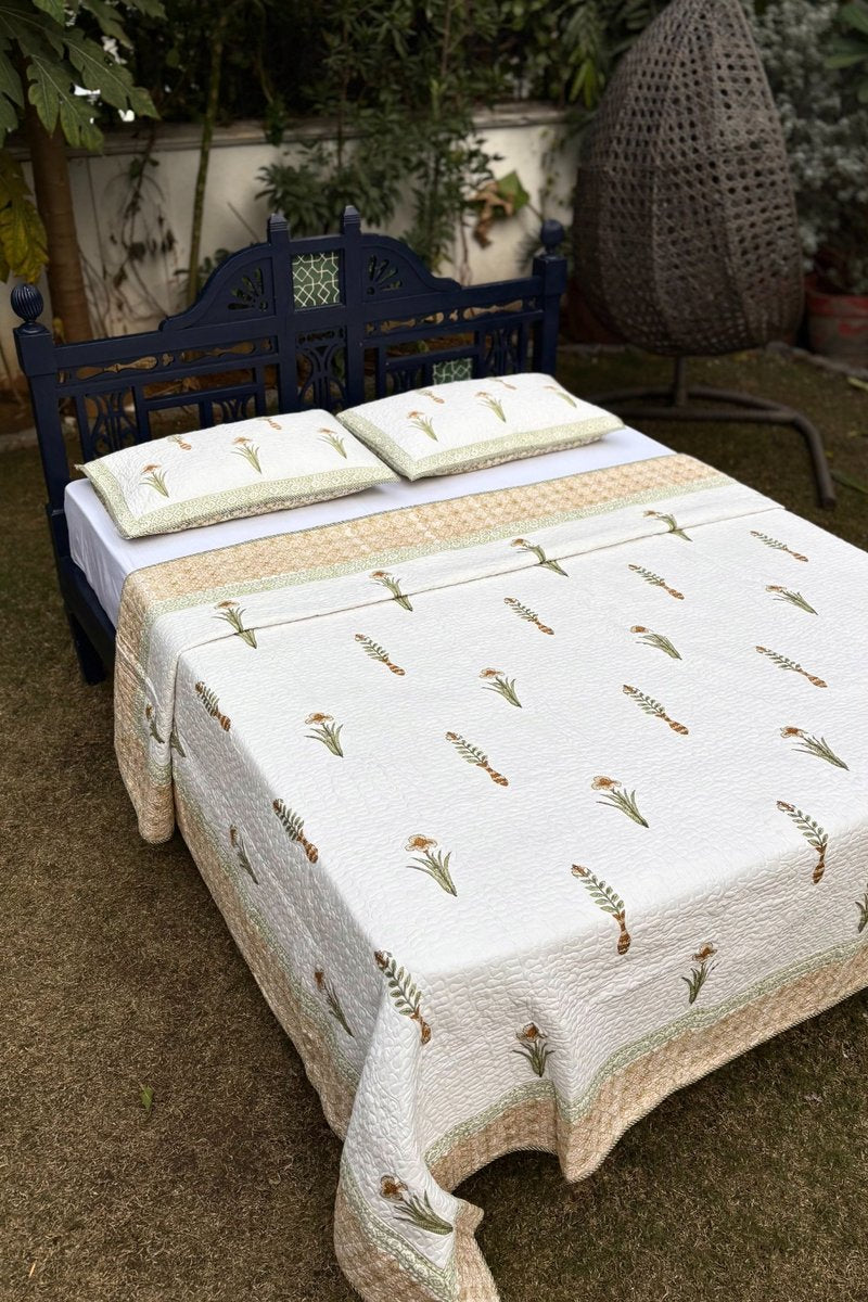 Reversible cotton quilted bedcover with sage green floral print and coordinated border, handcrafted Jaipur quilt