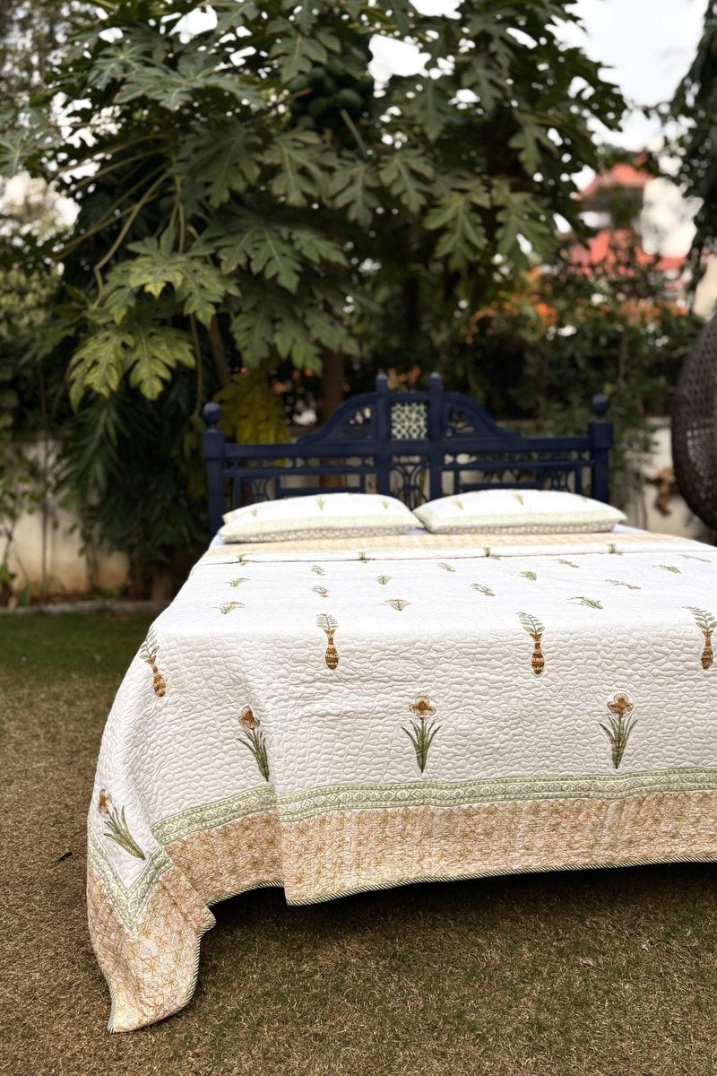 Premium white cotton quilted bedcover with sage green floral motifs and detailed border, reversible summer quilt India