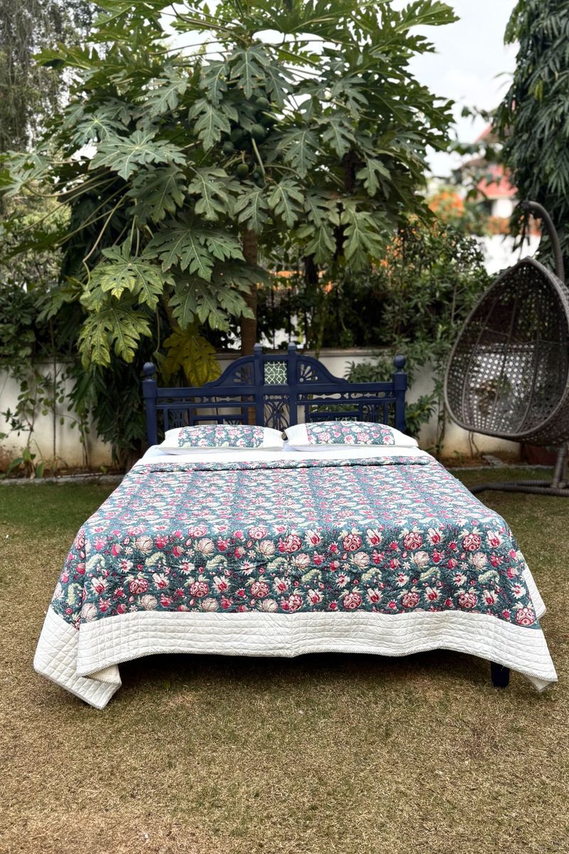 King size hand block printed quilt with floral design, handcrafted Indian cotton bedding outdoors