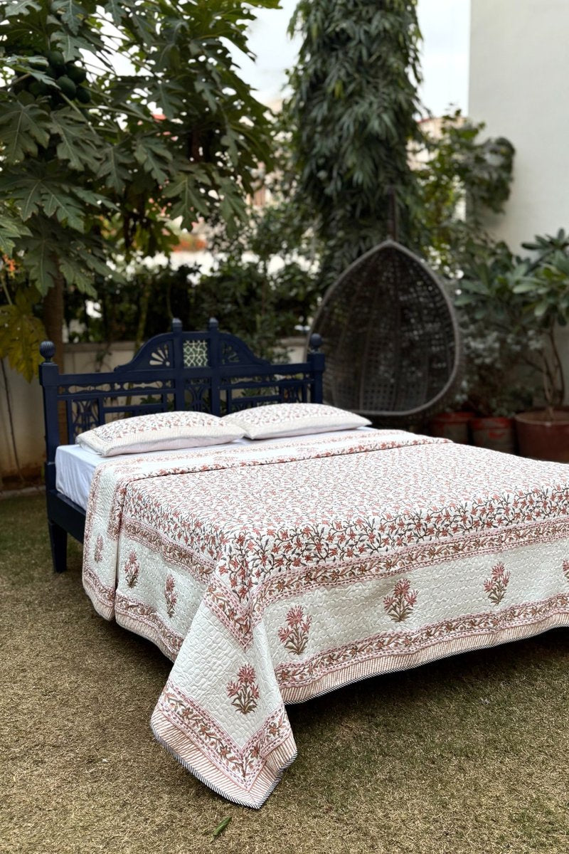Ivory and rust floral cotton quilt set with matching pillow covers, breathable summer quilt India