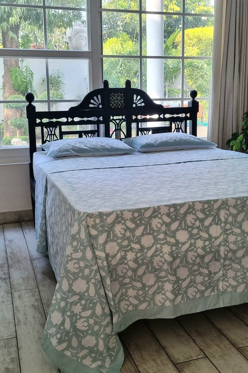Close up of mint floral cotton bedsheet and coordinated pillow covers with elegant vine print