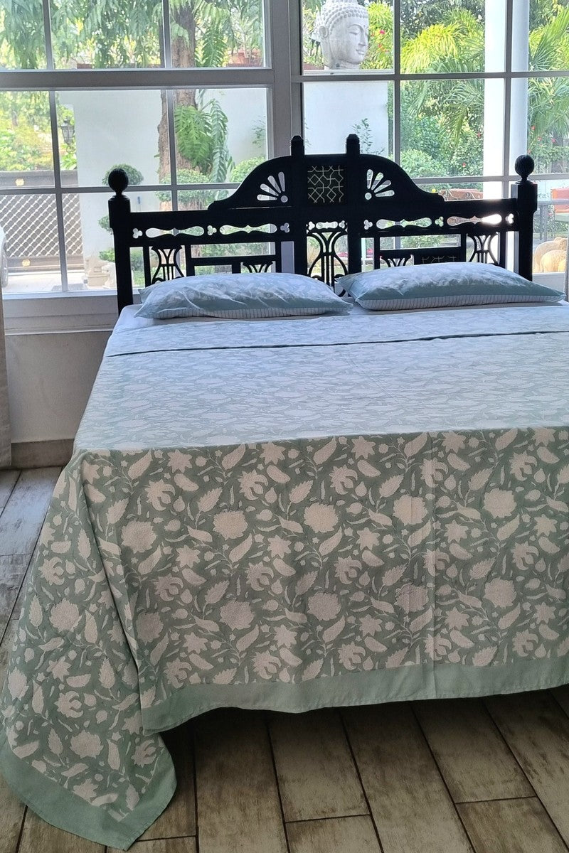 King size mint green floral cotton bedsheet styled on wooden bed with natural light background