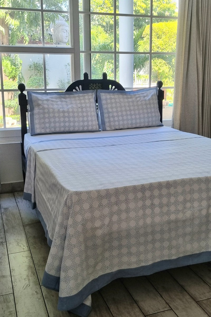 King size grey cotton bedsheet with elegant lattice block print pattern styled on wooden bed