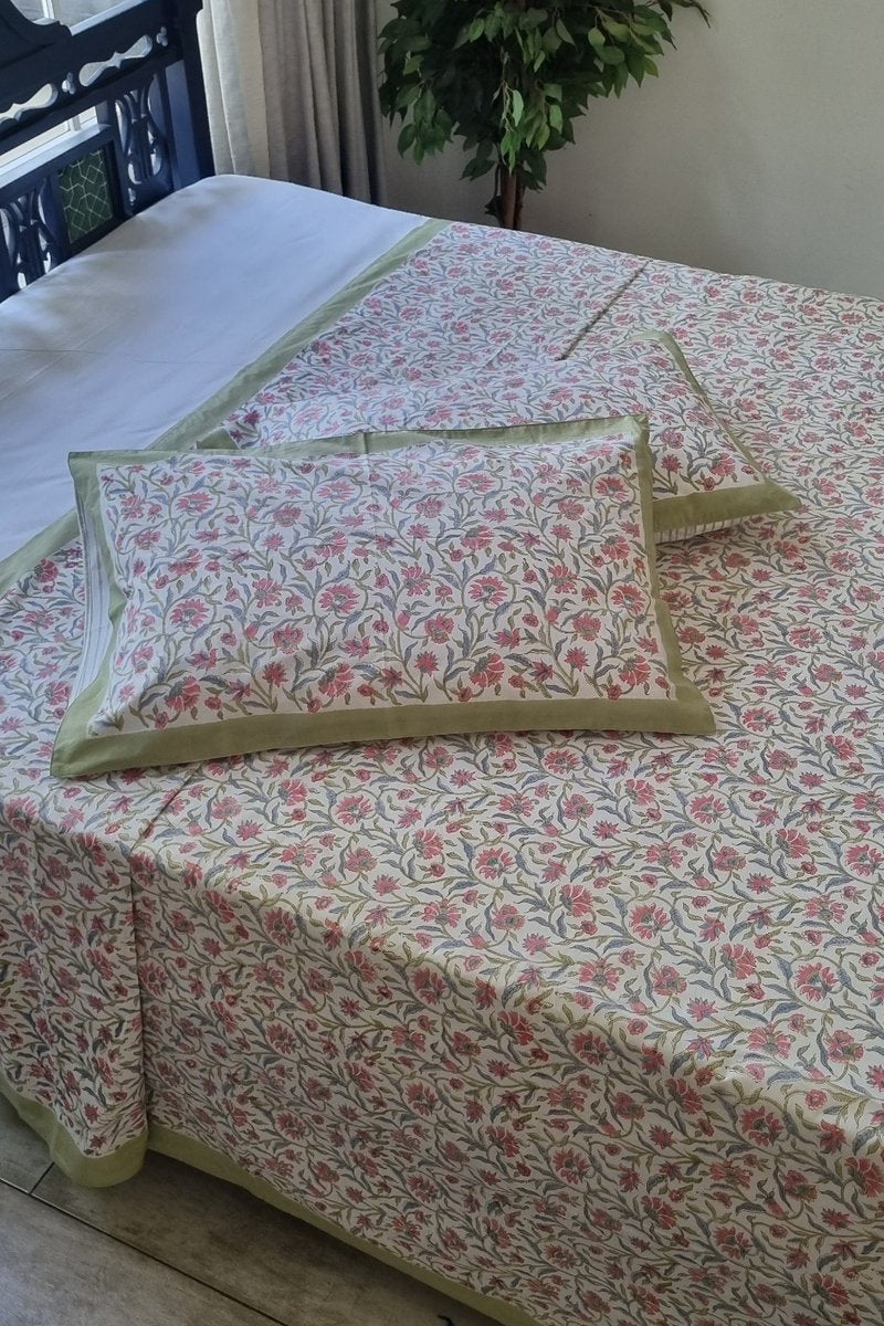 Indian hand block printed cotton bedsheet in pink floral pattern with olive green border styling