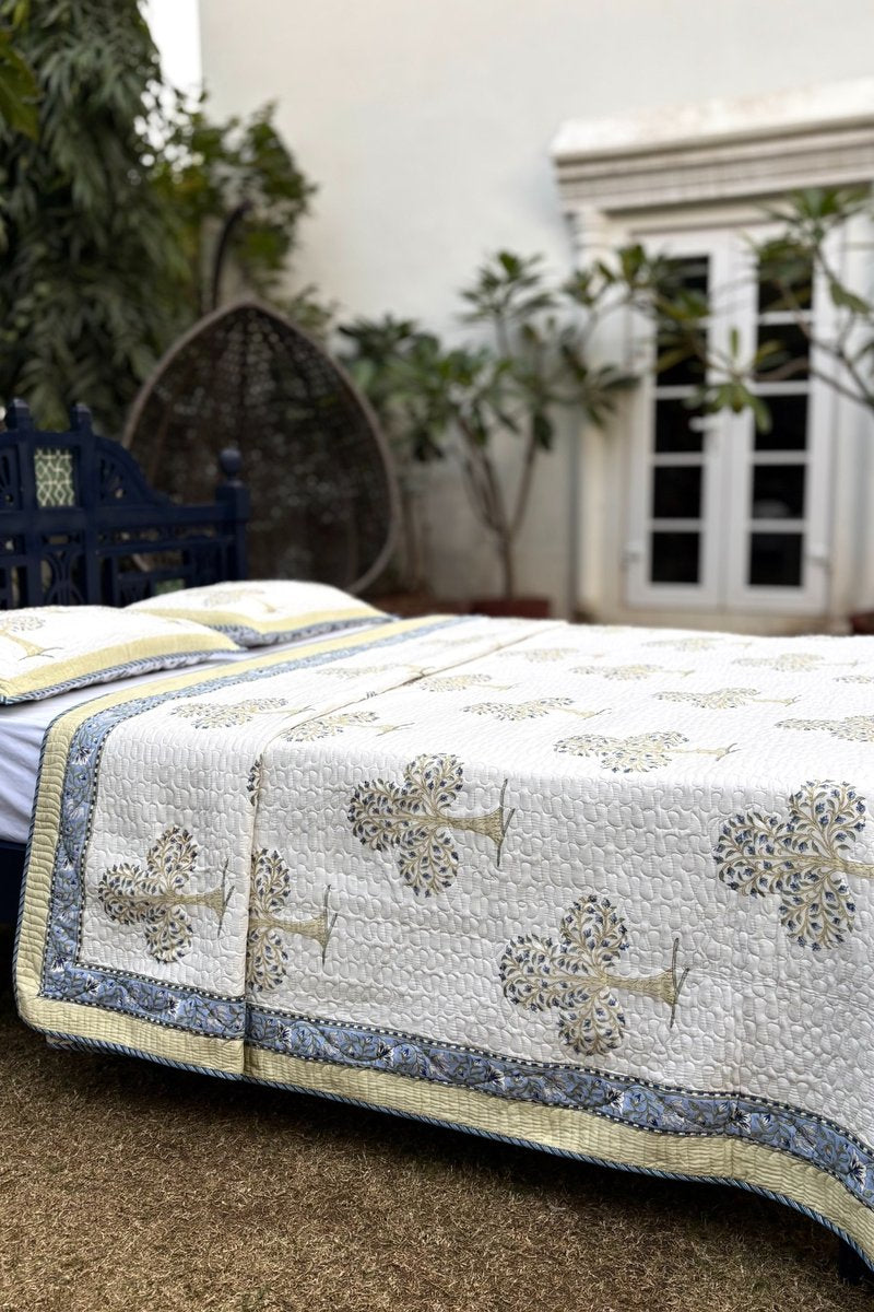 Hand block print quilted bedcover with Mughal tree motif and blue floral reverse pattern, handcrafted cotton bedding India