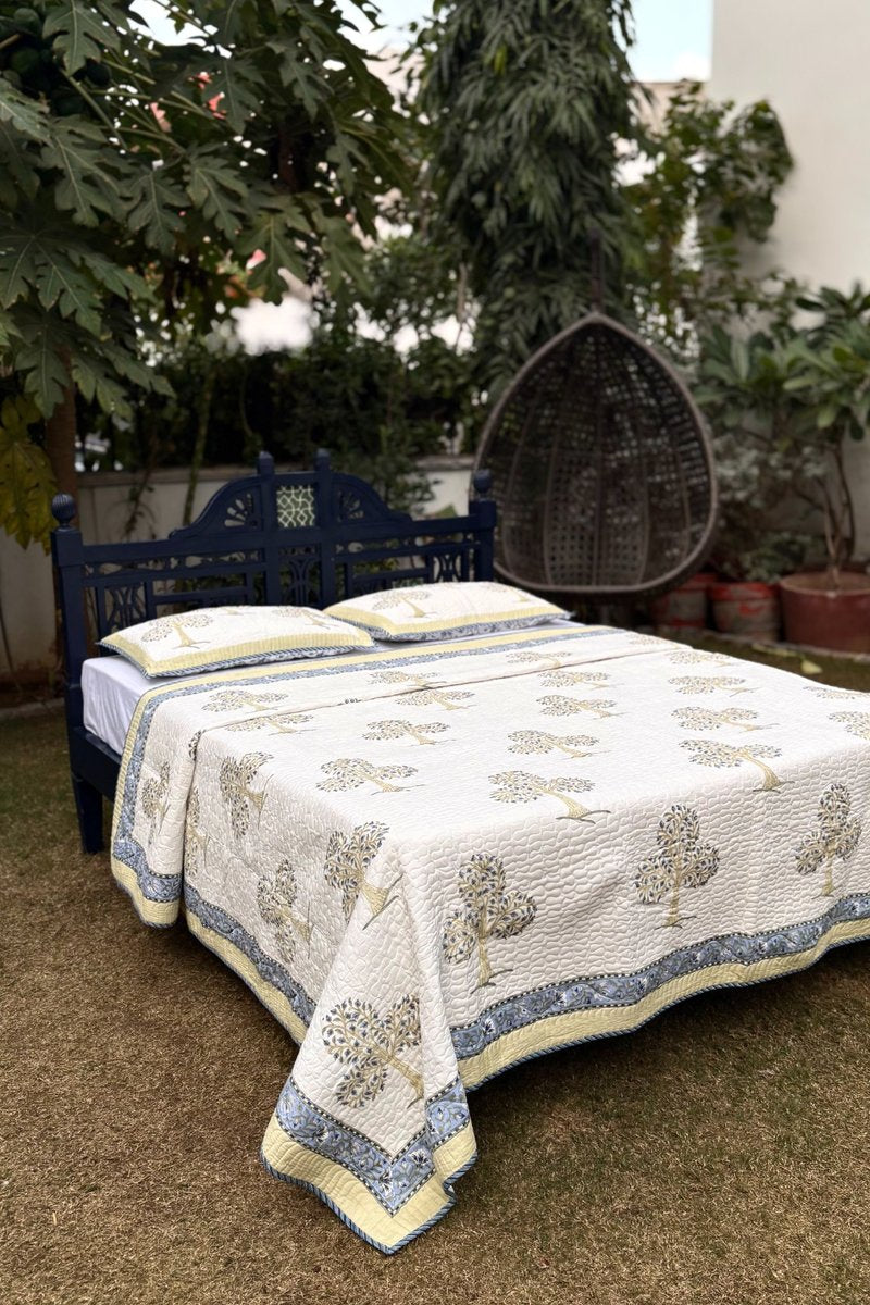 Blue tree hand block printed cotton quilted bedcover with floral border, luxury Jaipur bedding set in soft ivory base