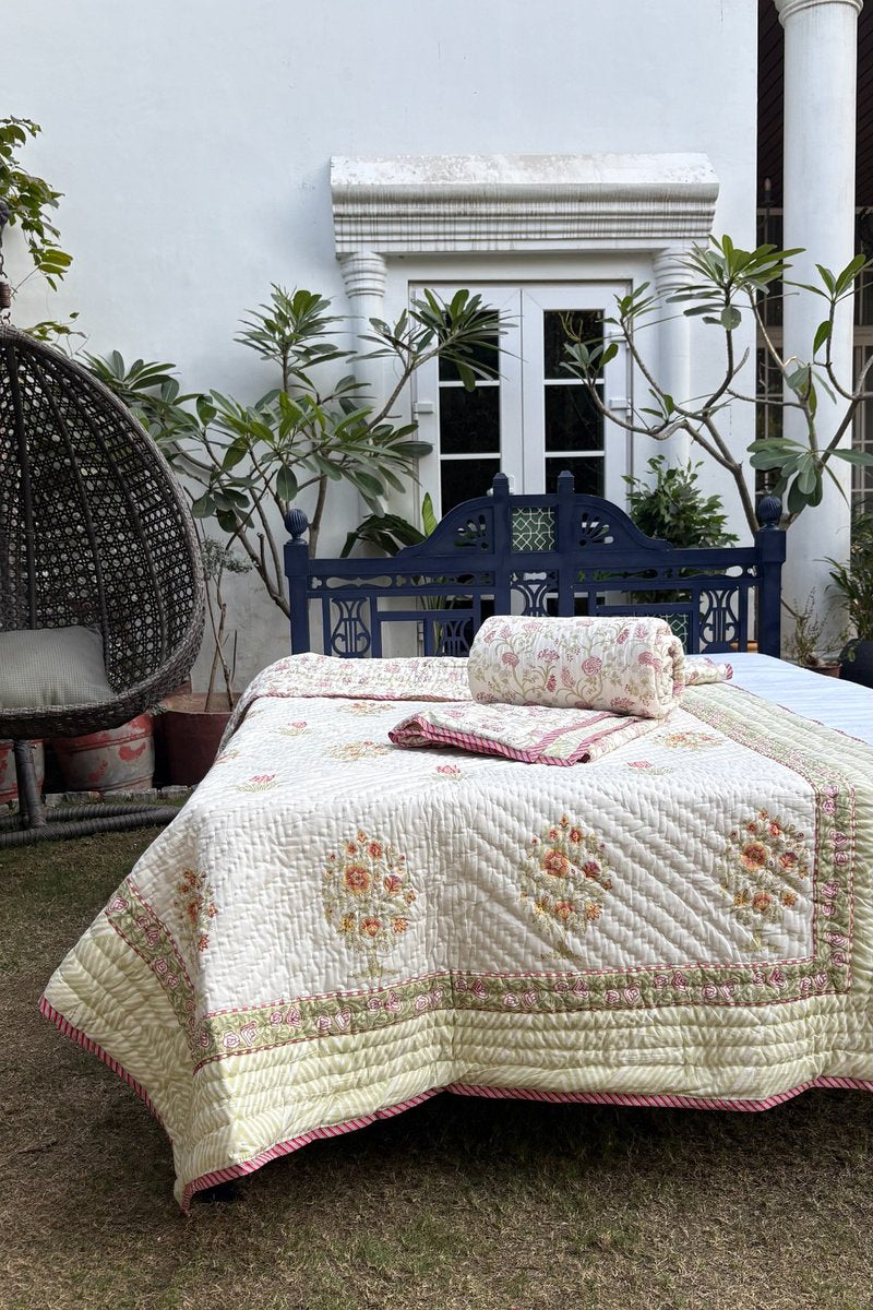 Cream floral cotton quilt set with pink and yellow hand block print and green border detailing