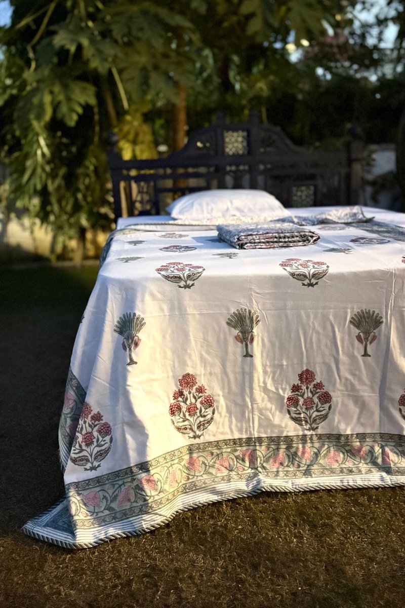 White cotton hand block print dohar with pink floral buta and green palm tree motifs, detailed floral border
