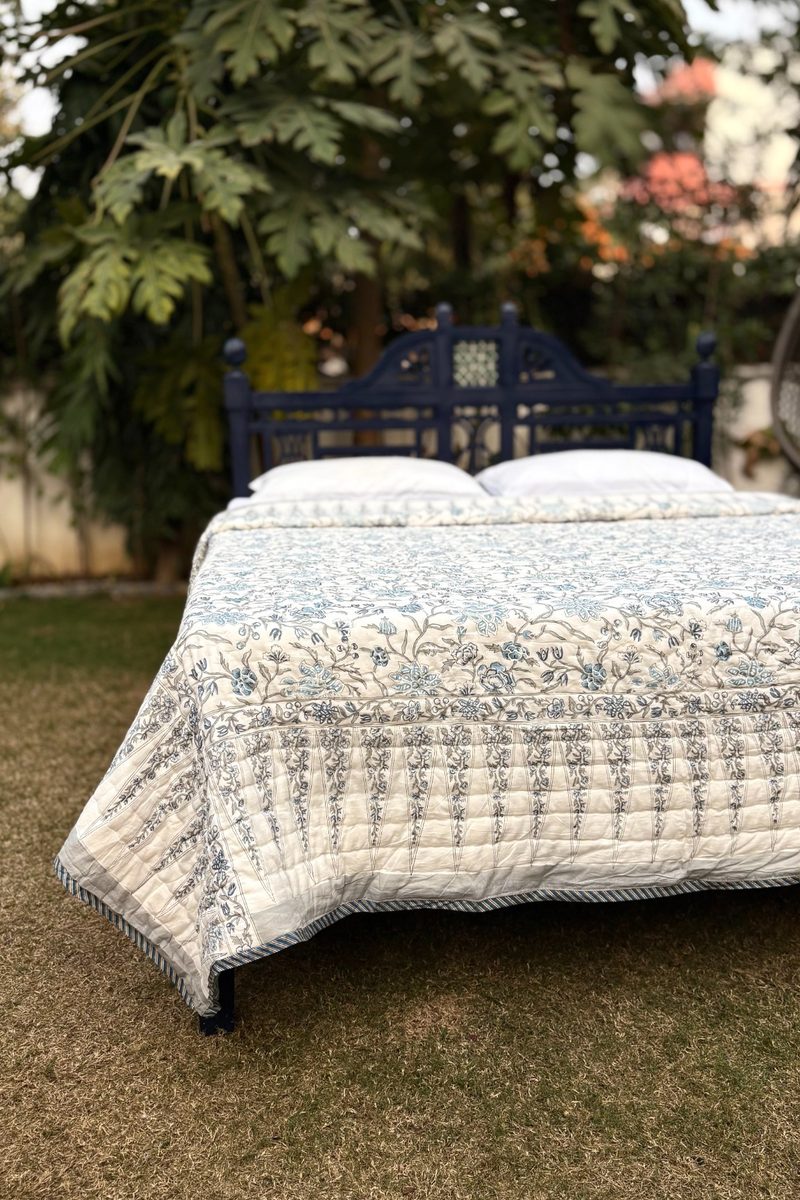 Handcrafted blue floral block print quilt with detailed border, premium cotton bedding for luxury bedrooms