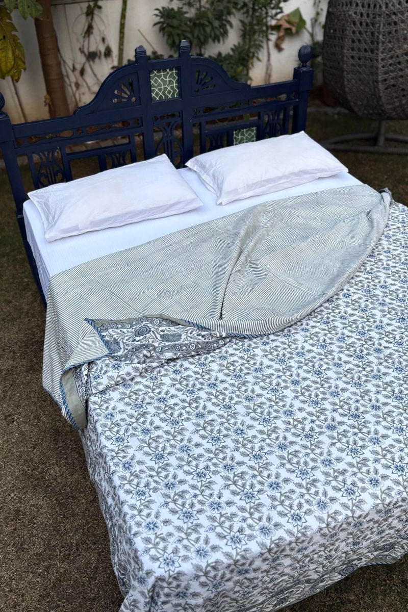 Reversible cotton dohar with blue floral front and subtle striped backing, handcrafted Jaipur bedcover