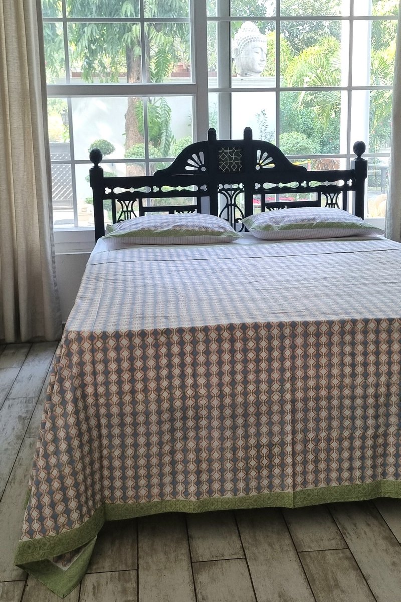 Matching block print pillow cover with geometric pattern and green edging