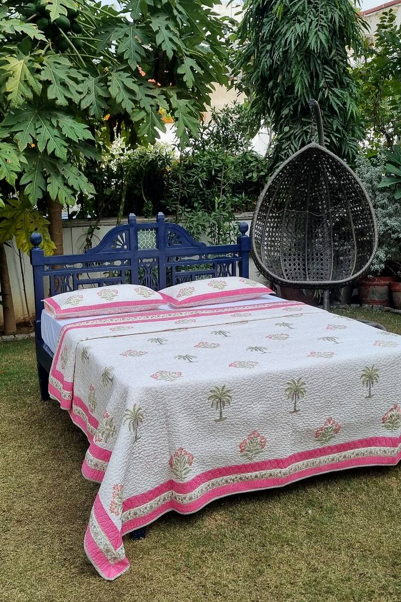 Hand block printed white cotton bedcover with palm tree and floral buta motifs and pink border