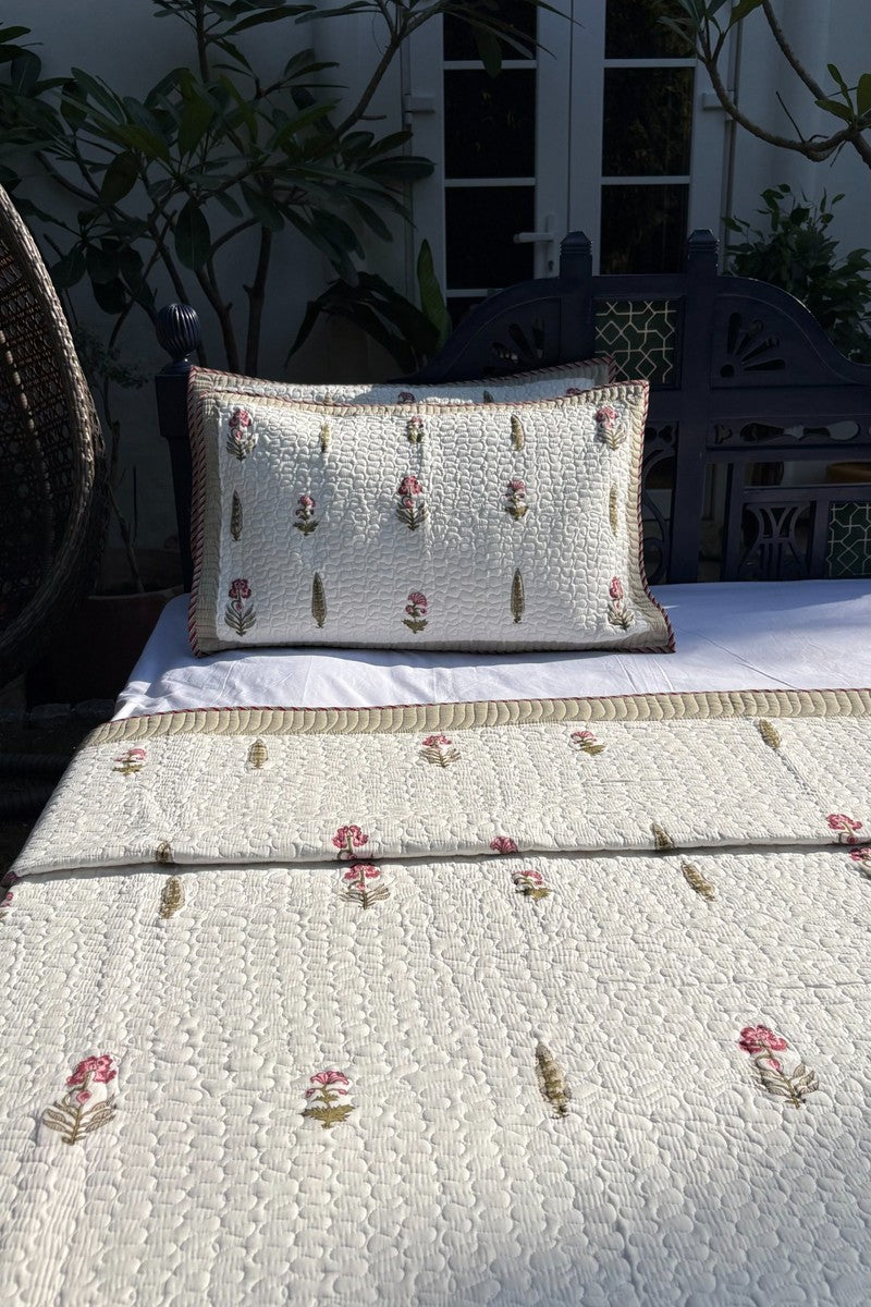 Luxury hand block printed cotton bedspread with green border and scattered floral motifs