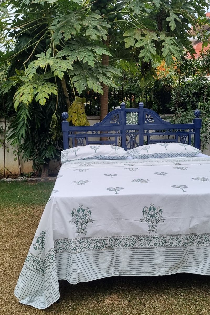 Green Mughal floral motif hand block printed bedsheet with striped hem and coordinated pillow covers