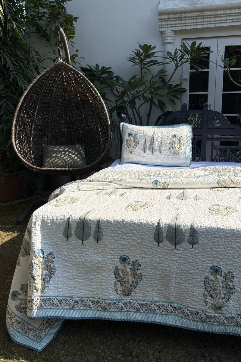 Close up of hand block printed cotton pillow cover with floral buta and leaf design